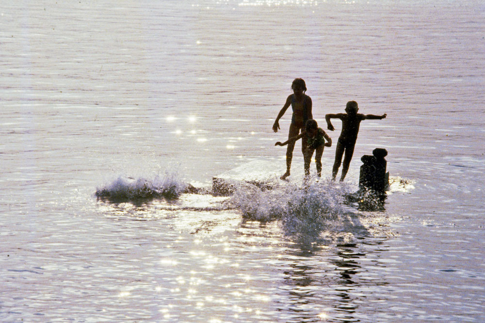 Photo of children diving off a lake raft in Maine