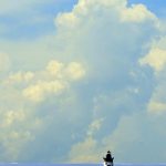 Photo of lighthouse and large clouds