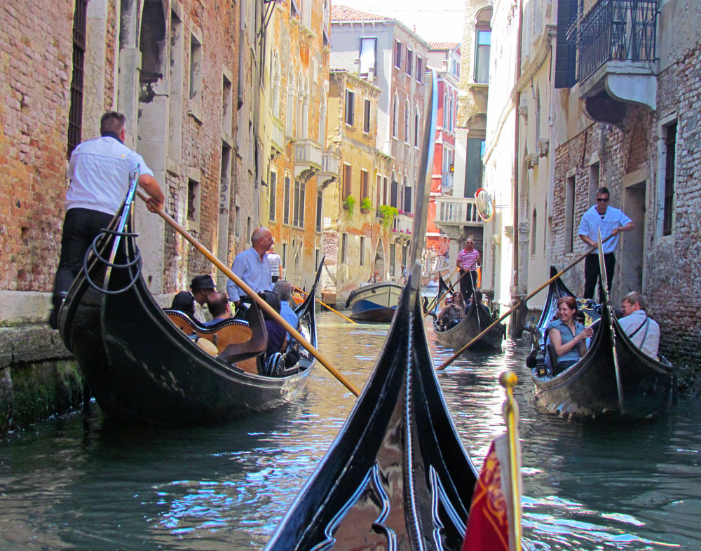 Photo of gondolas passing each other in Venice